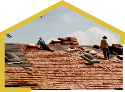 Couple of men working on a roof, performing roof repair